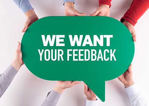 hands holding a bubble that says We Want Your Feedback