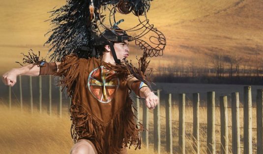 Man dancing with horse headpiece on