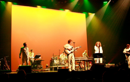 Supertramp Experience on stage performing on yellow and orange lit stage