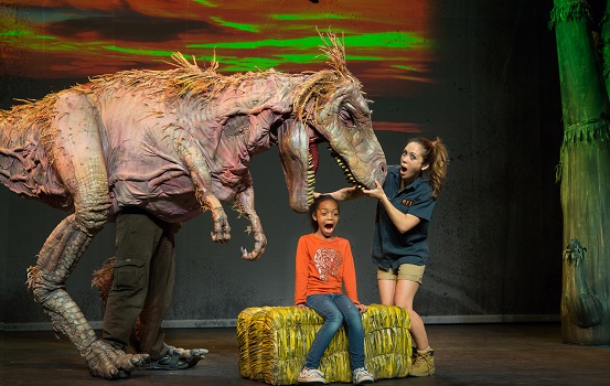 Dinosaur on stage with child and show Dinosaur Zoo Keeper
